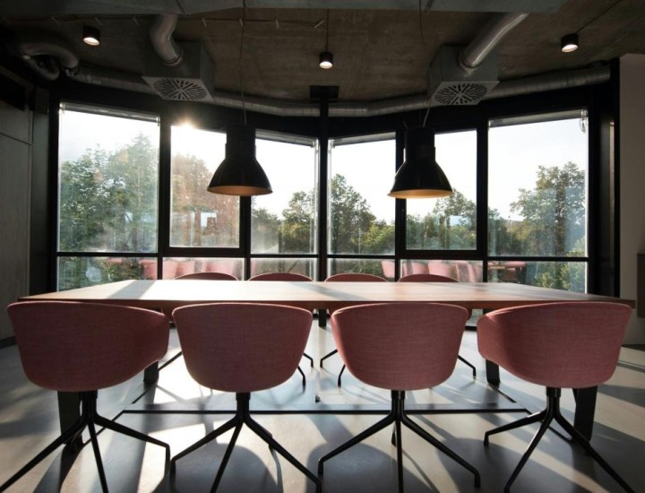 Empty chairs surround a conference table